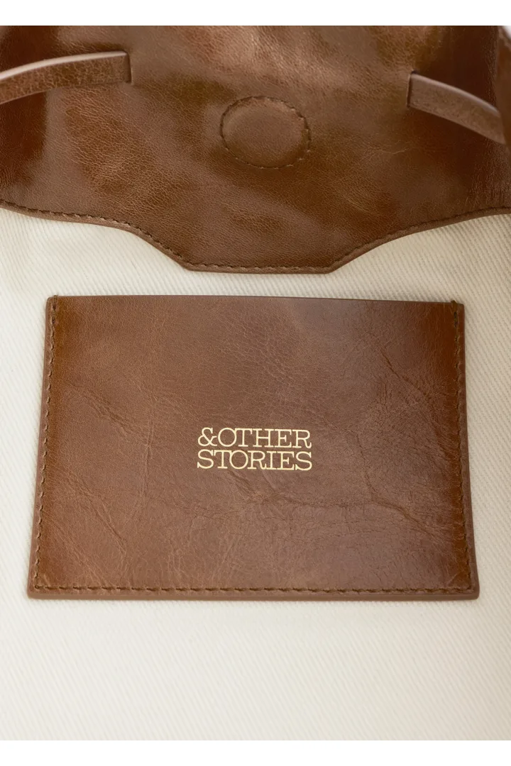 앤아더스토리즈 로우 프로파일 레더 숄더 백의 브라운컬러 Product입니다.